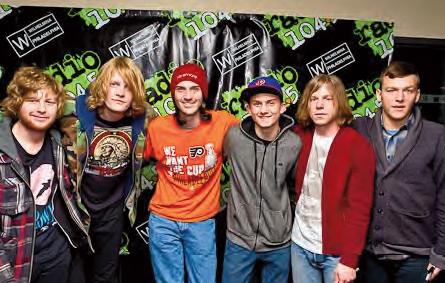 Steve Wermuth with th Flyers shirt standing with the band Cage The Elephant