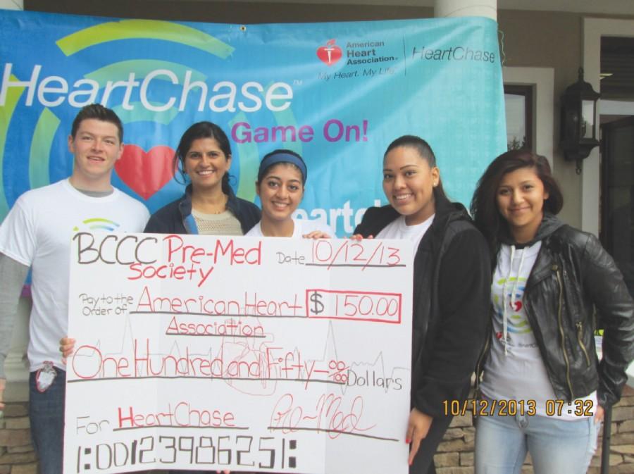 The+Pre-Med+society+donating+their+check+to+the+American+Heart+Association+on+the+day+of+the+event.+