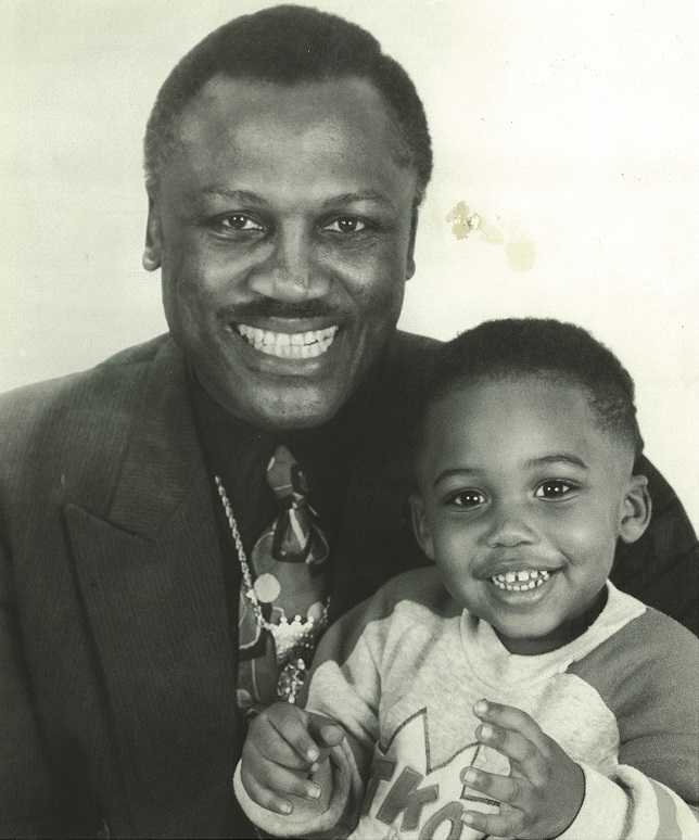 Joe Frazier holding his son Derek as a child.