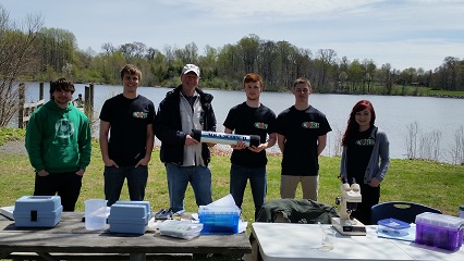 Members of CORE and their freshwater testing equipment by Lake Luxembourg, in Core Creek Park.