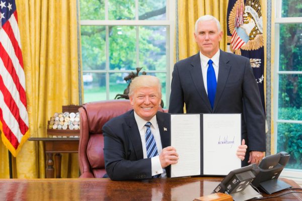 Trump signs a bill with his former vice president