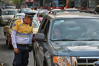 Photo of Mexico City Transit Police talking to a driver courtesy of Wikimedia Commons